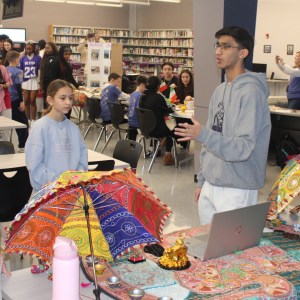 idk who explains to the kids what the umbrella means to the culture he is representing.